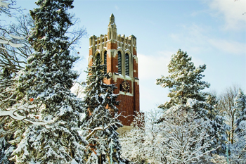 Beaumont tower surrounded by snow covered trees and snow on the ground